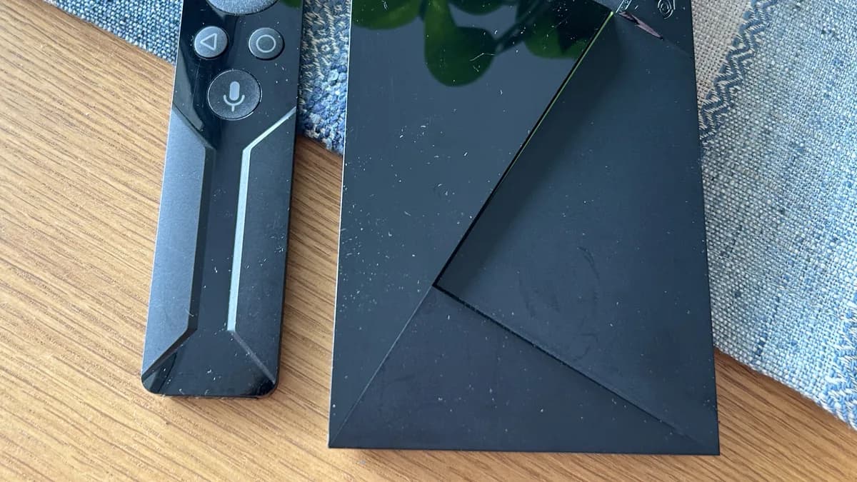 Android TV streaming box shown with its controller
