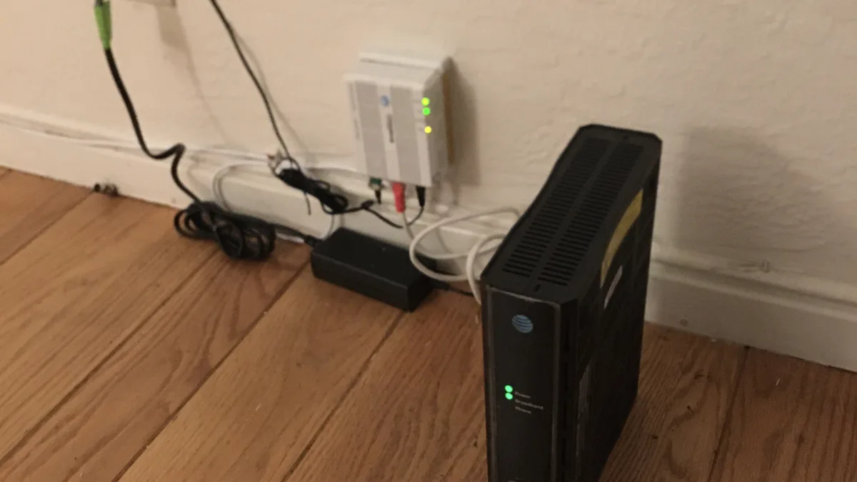 Home Wi-Fi router and modem on a shelf, a common source of IPTV buffering and freezing issues