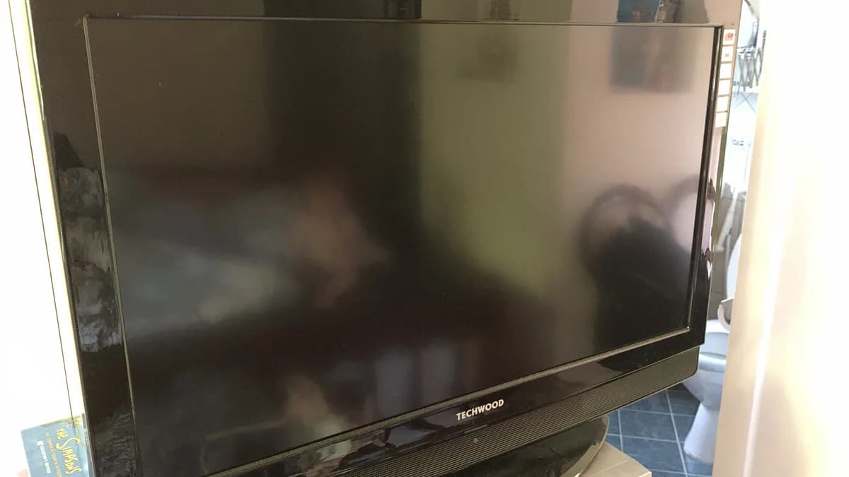 Flat-screen television with a black, powered-off display, representing IPTV channels not loading